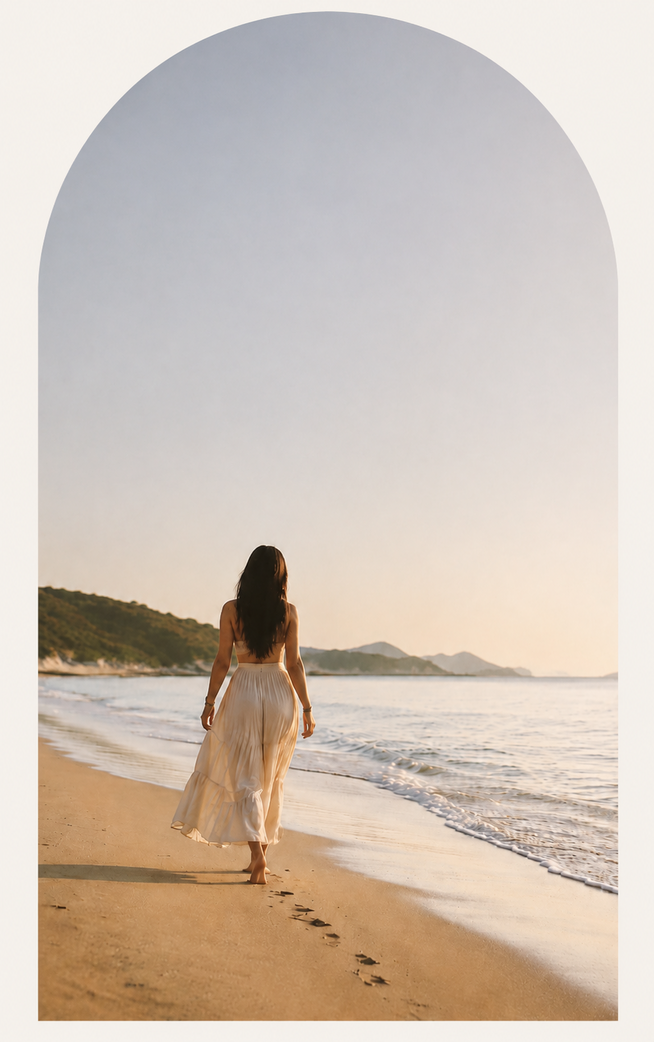 Mulher caminhando na praia em direção ao horizonte